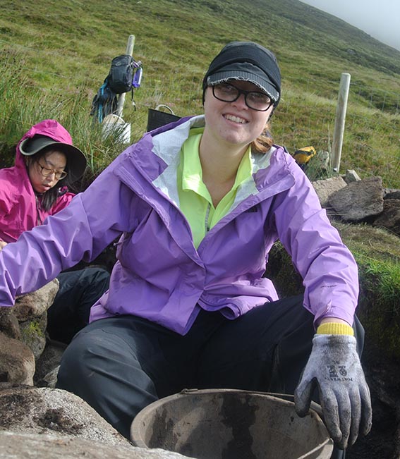 Happy archaeology student at dig site, Achill Island, Ireland