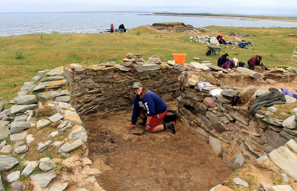 Archaeology student inside excavated cabin at Caraun Point, Achill Island